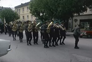 Images Dated 9th August 2012: Brass band marching along a street
