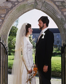 Bridegroom Gallery: Bride and groom in church doorway, Marazion, Cornwall
