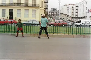Two British Caribbean boys roller skating in Brighton Engla