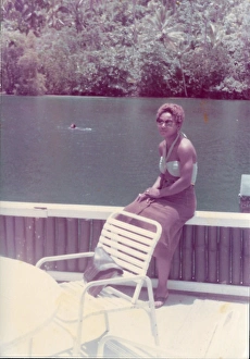 Images Dated 19th July 2016: British Caribbean woman sitting by the Blue Lagoon in Port A
