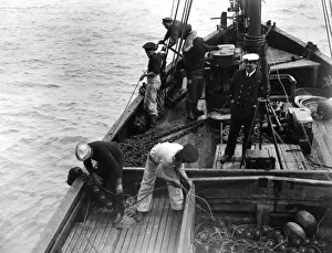 Floats Prints: British sailors laying anti-submarine nets from drifter, WW1