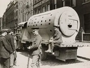 British troops by an improvised armoured car made of locomotive engine smoke-boxes, in Dublin, Ireland, outside the Granville Hotel in 1916 during the Easter Rising