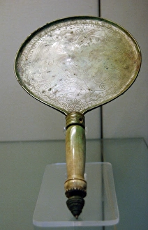 Bronze mirror with bone handle engraved with a scene depicti Bronze mirror with bone handle engraved with a scene depicti