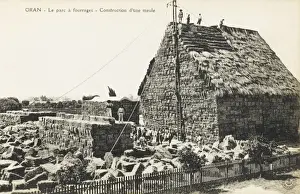 Building a mill at an outdoor hay store at Oran, Algeria