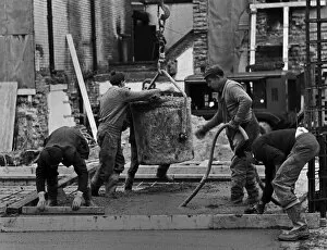 Building workers laying concrete, City of London
