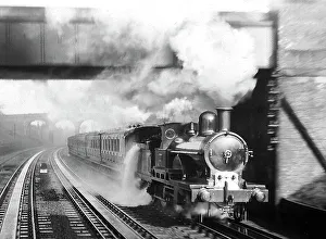 Bushey Steam Train picking up water early 1900s