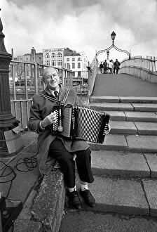Accordian Gallery: Busker plays an accordian on Ha penny Bridge, Dublin