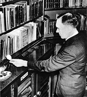 Librarian Prints: C. J. Purnell Holding an Incendiary Bomb