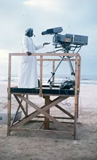 Salalah Prints: Cameraman in Oman on wooden platform