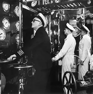 The captain checks the dials