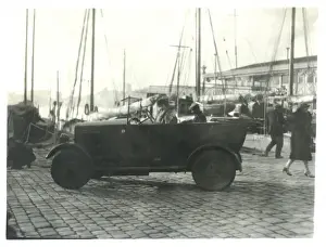 Cobble Stones Prints: Car at the docks with masts in the background