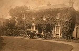 Car parked outside detached house with ivy