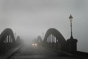 Visibility Gallery: A car in thick fog on the concrete bridge over the River Dee
