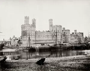 Cityscape Collection: Carnarvon Castle, Wales, boats in the foreground