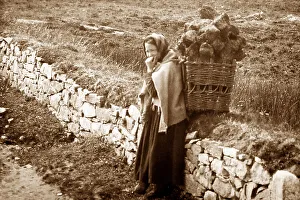 Carrying turf in a creel, West of Ireland, early 1900s