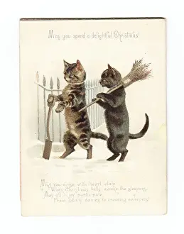 Two cats clearing snow on a movable Christmas card