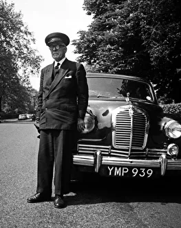 Chauffeur standing by his car