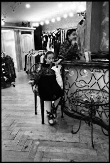 Images Dated 3rd September 2015: Child and assistant interior Egyptian clothing store, Egypt. Date: 1980s