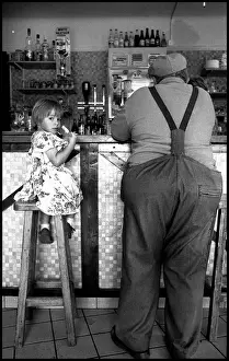Child and old man in bar, Normandy, France