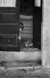 Curious Gallery: Child peeping round door, Lisbon
