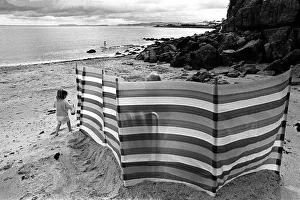 Images Dated 8th August 2019: A child plays on Benllech beach, Anglesey north Wales