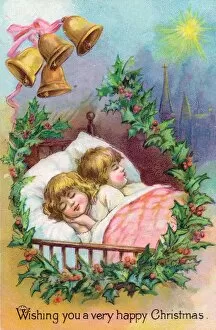 Two children asleep in bed on a Christmas card