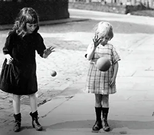 Children bouncing balls, early 1900s