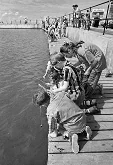 Pairs Prints: Children crabbing from a wooden pontoon at New Brighton