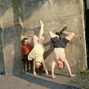 Watching Prints: Children doing handstands on a Balham street, SW London