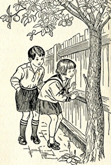 Images Dated 22nd March 2012: Two children hide behind a wooden fence