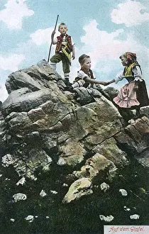 Three children on a high rock, Switzerland