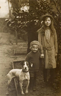 Russell Gallery: Two children with Jack Russell terrier in a garden