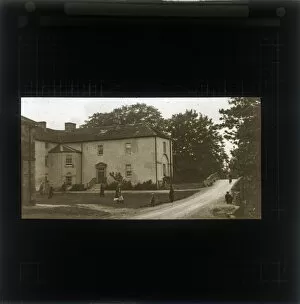 Children Playing outside a house on a village green