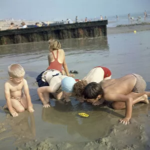 Images Dated 26th May 2017: Children playing in a pool on a sandy beach