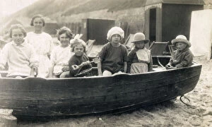 Children playing in rowing boat on beach at Gorleston-on-Sea