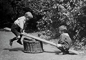 Children playing on a see-saw early 1900s