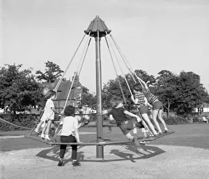 Enjoyment Prints: Children playing on an umbrella roundabout