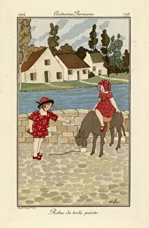 Two children in printed toile summer outfits with a donkey
