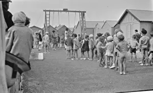 Swings Prints: Children queueing up for a ride on the swings