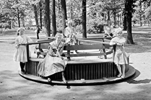 Images Dated 7th March 2017: Children riding a Merry-go-round roundabout in Clark Park, D