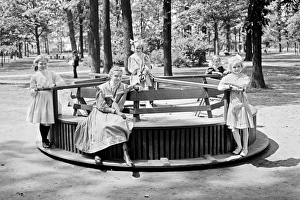 Images Dated 7th March 2017: Children riding a Merry-go-round roundabout in Clark Park, D