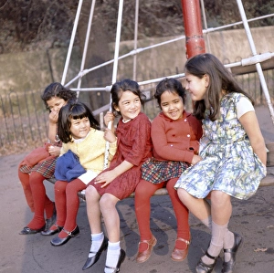 Images Dated 26th May 2017: Five children on a roundabout in a park