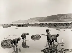 Children sailing boats in the sea, Runswick Baay Yorkshire