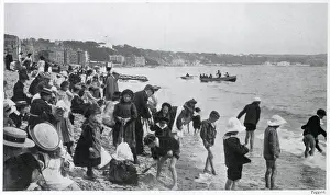 Children on the sands in a wide assortment of clothing Date: 1905