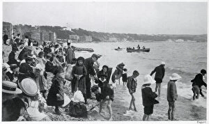 Children on the sands in a wide assortment of clothing Date: 1905