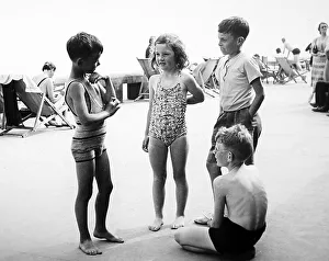 Deckchairs Prints: Children at the seaside, probably 1940s