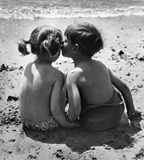 Two children sitting on a beach