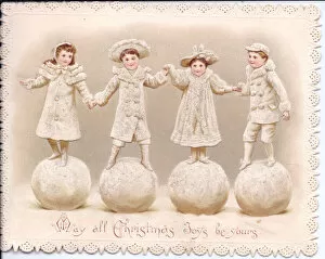 Images Dated 23rd November 2015: Four children stand on large snowballs on a Christmas card