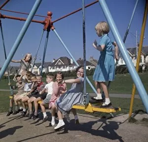 Images Dated 26th May 2017: Children on a swing in a park