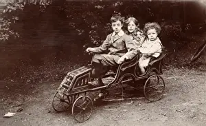 Pedal Prints: Three children in a toy car